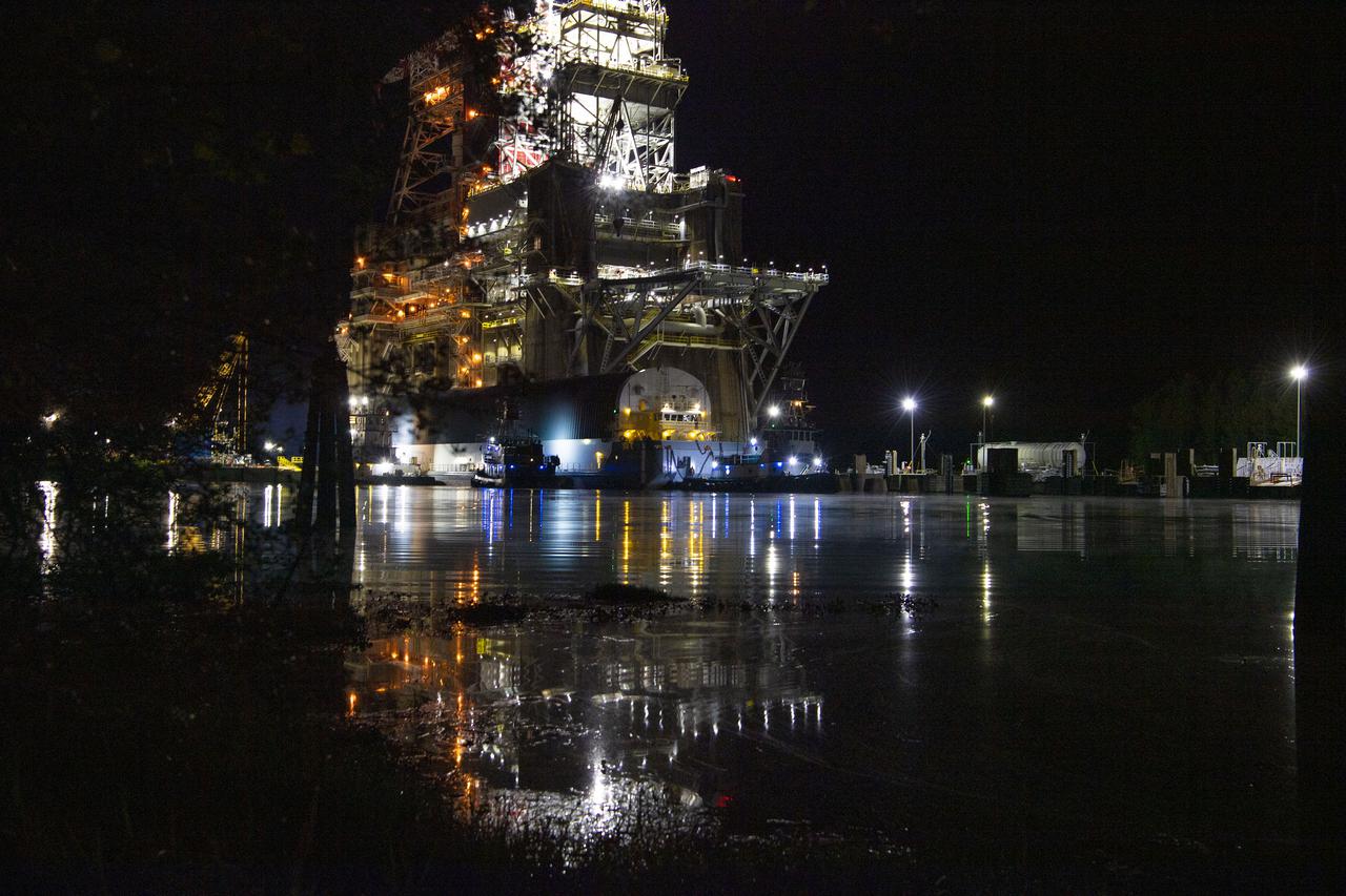The first core stage of NASA’s Space Launch System (SLS) rocket, loaded onto the agency’s Pegasus barge, departs Stennis Space Center near Bay St. Louis, Mississippi, headed to Kennedy Space Center in Florida. The departure of the core stage in mid-April 2021 followed completion of a Green Run test series of the stage systems in preparation for its launch on the Artemis I mission. The Green Run series concluded with a March 18 hot fire of the stage’s four RS-25 engines on the B-2 Test Stand at Stennis, just as during an actual launch. Following refurbishment work, the stage was removed from the B-2 stand and loaded onto the Pegasus barge for transport. Once at Kennedy, the will be integrated with the rest of SLS rocket and prepared for the launch of the Artemis I mission to the Moon. Photo Credit: NASA