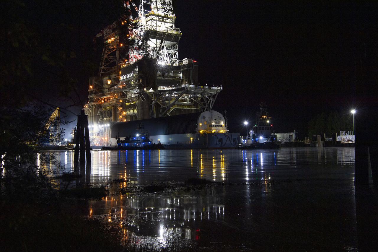 The first core stage of NASA’s Space Launch System (SLS) rocket, loaded onto the agency’s Pegasus barge, departs Stennis Space Center near Bay St. Louis, Mississippi, headed to Kennedy Space Center in Florida. The departure of the core stage in mid-April 2021 followed completion of a Green Run test series of the stage systems in preparation for its launch on the Artemis I mission. The Green Run series concluded with a March 18 hot fire of the stage’s four RS-25 engines on the B-2 Test Stand at Stennis, just as during an actual launch. Following refurbishment work, the stage was removed from the B-2 stand and loaded onto the Pegasus barge for transport. Once at Kennedy, the will be integrated with the rest of SLS rocket and prepared for the launch of the Artemis I mission to the Moon. Photo Credit: NASA