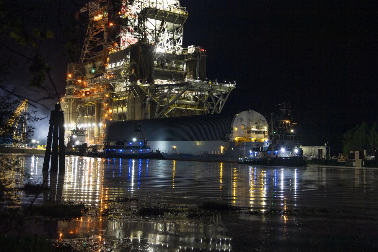 The first core stage of NASA’s Space Launch System (SLS) rocket, loaded onto the agency’s Pegasus barge, departs Stennis Space Center near Bay St. Louis, Mississippi, headed to Kennedy Space Center in Florida. The departure of the core stage in mid-April 2021 followed completion of a Green Run test series of the stage systems in preparation for its launch on the Artemis I mission. The Green Run series concluded with a March 18 hot fire of the stage’s four RS-25 engines on the B-2 Test Stand at Stennis, just as during an actual launch. Following refurbishment work, the stage was removed from the B-2 stand and loaded onto the Pegasus barge for transport. Once at Kennedy, the will be integrated with the rest of SLS rocket and prepared for the launch of the Artemis I mission to the Moon. Photo Credit: NASA