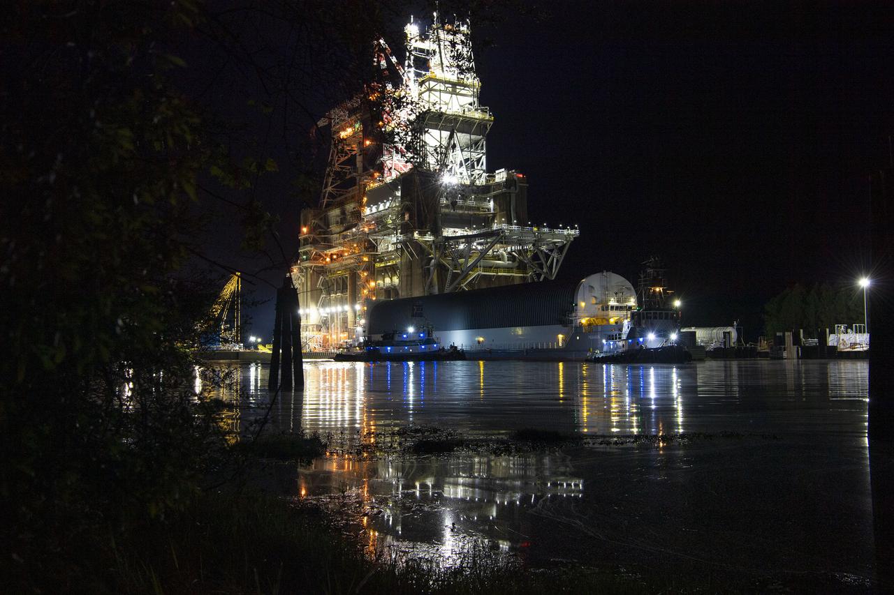The first core stage of NASA’s Space Launch System (SLS) rocket, loaded onto the agency’s Pegasus barge, departs Stennis Space Center near Bay St. Louis, Mississippi, headed to Kennedy Space Center in Florida. The departure of the core stage in mid-April 2021 followed completion of a Green Run test series of the stage systems in preparation for its launch on the Artemis I mission. The Green Run series concluded with a March 18 hot fire of the stage’s four RS-25 engines on the B-2 Test Stand at Stennis, just as during an actual launch. Following refurbishment work, the stage was removed from the B-2 stand and loaded onto the Pegasus barge for transport. Once at Kennedy, the will be integrated with the rest of SLS rocket and prepared for the launch of the Artemis I mission to the Moon. Photo Credit: NASA