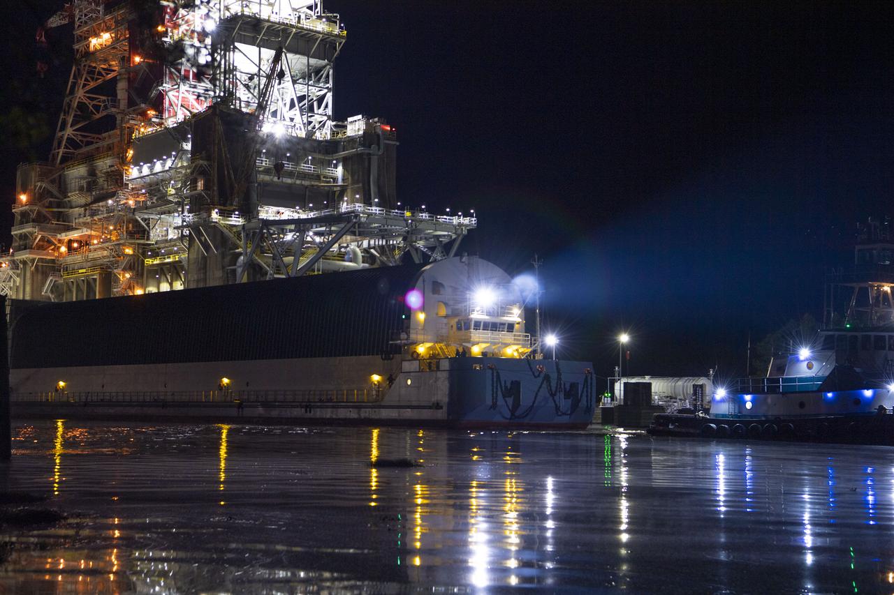 The first core stage of NASA’s Space Launch System (SLS) rocket, loaded onto the agency’s Pegasus barge, departs Stennis Space Center near Bay St. Louis, Mississippi, headed to Kennedy Space Center in Florida. The departure of the core stage in mid-April 2021 followed completion of a Green Run test series of the stage systems in preparation for its launch on the Artemis I mission. The Green Run series concluded with a March 18 hot fire of the stage’s four RS-25 engines on the B-2 Test Stand at Stennis, just as during an actual launch. Following refurbishment work, the stage was removed from the B-2 stand and loaded onto the Pegasus barge for transport. Once at Kennedy, the will be integrated with the rest of SLS rocket and prepared for the launch of the Artemis I mission to the Moon. Photo Credit: NASA
