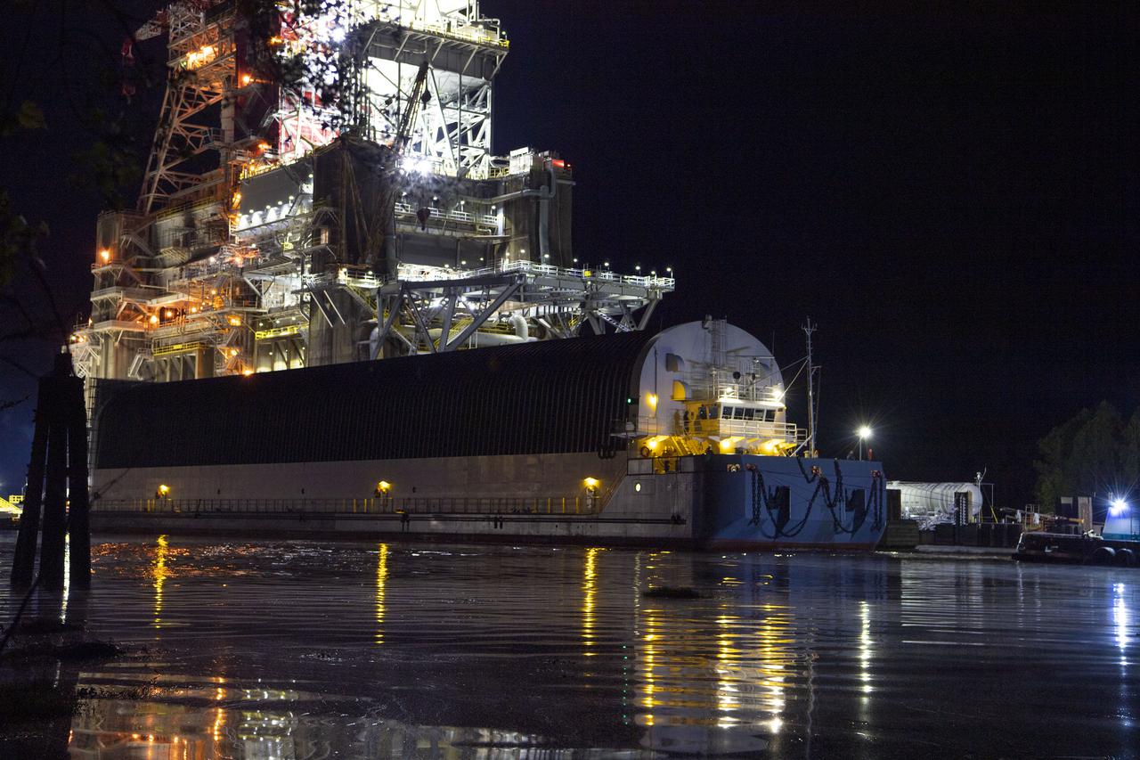 The first core stage of NASA’s Space Launch System (SLS) rocket, loaded onto the agency’s Pegasus barge, departs Stennis Space Center near Bay St. Louis, Mississippi, headed to Kennedy Space Center in Florida. The departure of the core stage in mid-April 2021 followed completion of a Green Run test series of the stage systems in preparation for its launch on the Artemis I mission. The Green Run series concluded with a March 18 hot fire of the stage’s four RS-25 engines on the B-2 Test Stand at Stennis, just as during an actual launch. Following refurbishment work, the stage was removed from the B-2 stand and loaded onto the Pegasus barge for transport. Once at Kennedy, the will be integrated with the rest of SLS rocket and prepared for the launch of the Artemis I mission to the Moon. Photo Credit: NASA