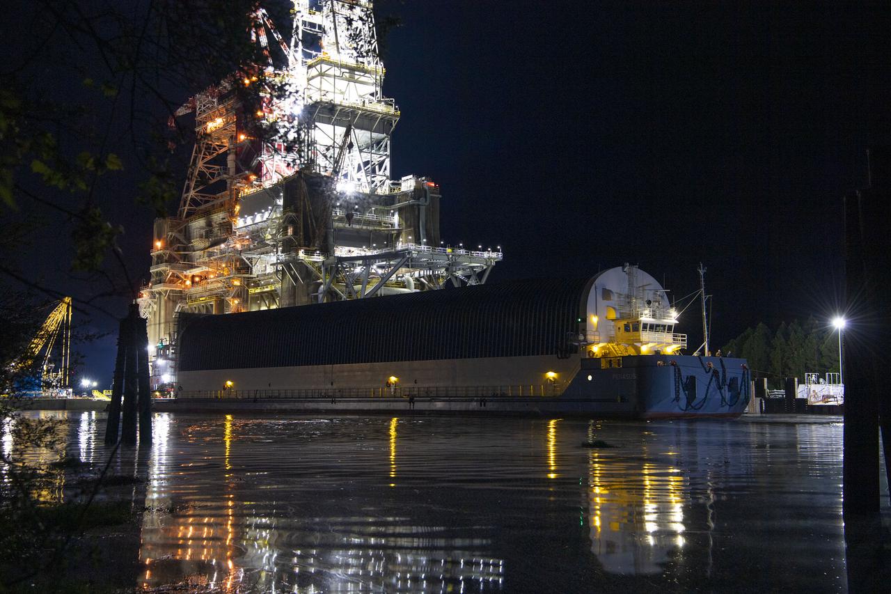 The first core stage of NASA’s Space Launch System (SLS) rocket, loaded onto the agency’s Pegasus barge, departs Stennis Space Center near Bay St. Louis, Mississippi, headed to Kennedy Space Center in Florida. The departure of the core stage in mid-April 2021 followed completion of a Green Run test series of the stage systems in preparation for its launch on the Artemis I mission. The Green Run series concluded with a March 18 hot fire of the stage’s four RS-25 engines on the B-2 Test Stand at Stennis, just as during an actual launch. Following refurbishment work, the stage was removed from the B-2 stand and loaded onto the Pegasus barge for transport. Once at Kennedy, the will be integrated with the rest of SLS rocket and prepared for the launch of the Artemis I mission to the Moon. Photo Credit: NASA