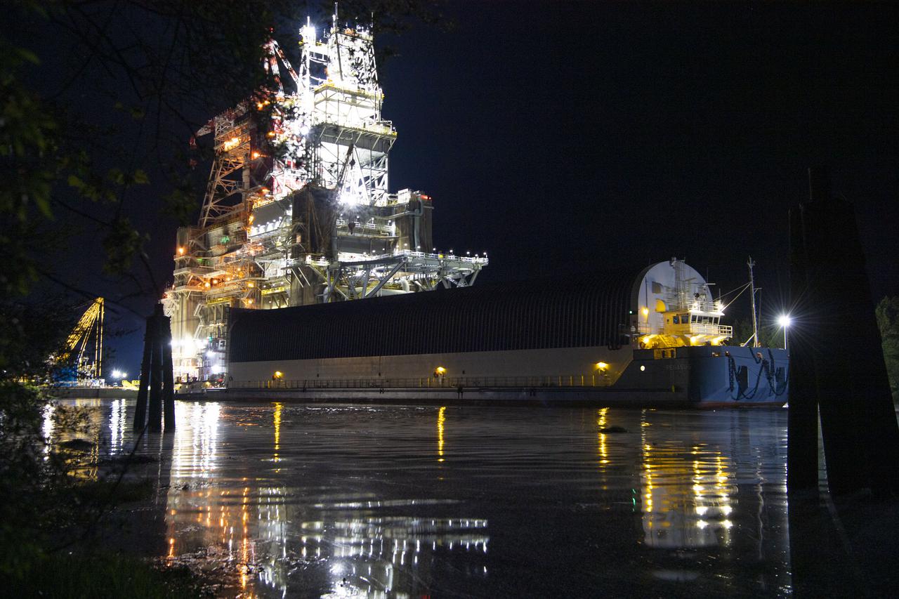 The first core stage of NASA’s Space Launch System (SLS) rocket, loaded onto the agency’s Pegasus barge, departs Stennis Space Center near Bay St. Louis, Mississippi, headed to Kennedy Space Center in Florida. The departure of the core stage in mid-April 2021 followed completion of a Green Run test series of the stage systems in preparation for its launch on the Artemis I mission. The Green Run series concluded with a March 18 hot fire of the stage’s four RS-25 engines on the B-2 Test Stand at Stennis, just as during an actual launch. Following refurbishment work, the stage was removed from the B-2 stand and loaded onto the Pegasus barge for transport. Once at Kennedy, the will be integrated with the rest of SLS rocket and prepared for the launch of the Artemis I mission to the Moon. Photo Credit: NASA