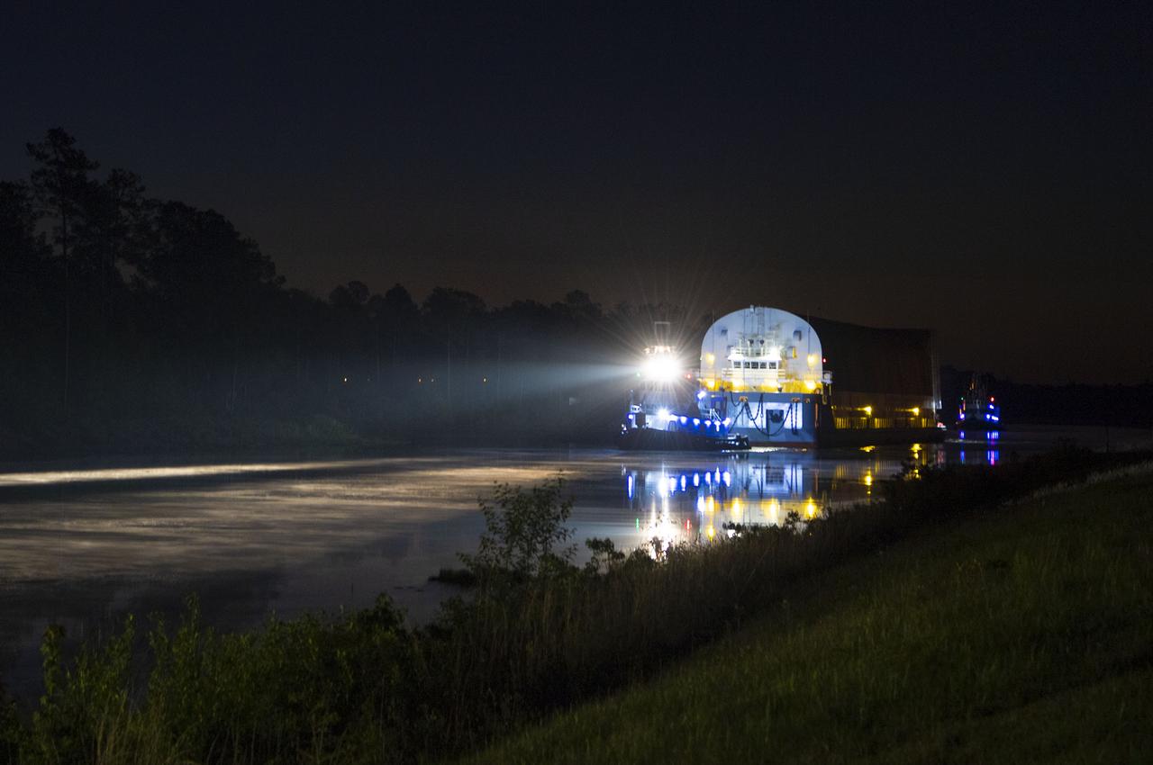 The first core stage of NASA’s Space Launch System (SLS) rocket, loaded onto the agency’s Pegasus barge, departs Stennis Space Center near Bay St. Louis, Mississippi, headed to Kennedy Space Center in Florida. The departure of the core stage in mid-April 2021 followed completion of a Green Run test series of the stage systems in preparation for its launch on the Artemis I mission. The Green Run series concluded with a March 18 hot fire of the stage’s four RS-25 engines on the B-2 Test Stand at Stennis, just as during an actual launch. Following refurbishment work, the stage was removed from the B-2 stand and loaded onto the Pegasus barge for transport. Once at Kennedy, the will be integrated with the rest of SLS rocket and prepared for the launch of the Artemis I mission to the Moon. Photo Credit: NASA