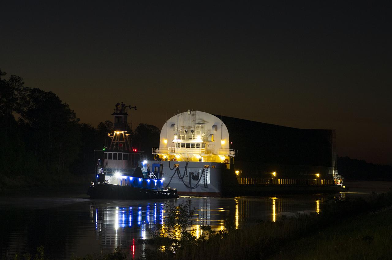 The first core stage of NASA’s Space Launch System (SLS) rocket, loaded onto the agency’s Pegasus barge, departs Stennis Space Center near Bay St. Louis, Mississippi, headed to Kennedy Space Center in Florida. The departure of the core stage in mid-April 2021 followed completion of a Green Run test series of the stage systems in preparation for its launch on the Artemis I mission. The Green Run series concluded with a March 18 hot fire of the stage’s four RS-25 engines on the B-2 Test Stand at Stennis, just as during an actual launch. Following refurbishment work, the stage was removed from the B-2 stand and loaded onto the Pegasus barge for transport. Once at Kennedy, the will be integrated with the rest of SLS rocket and prepared for the launch of the Artemis I mission to the Moon. Photo Credit: NASA