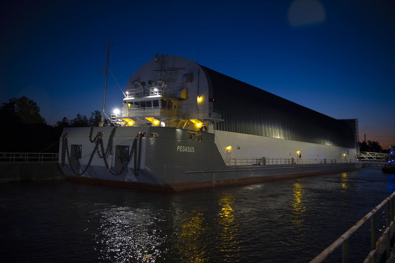 The first core stage of NASA’s Space Launch System (SLS) rocket, loaded onto the agency’s Pegasus barge, departs Stennis Space Center near Bay St. Louis, Mississippi, headed to Kennedy Space Center in Florida. The departure of the core stage in mid-April 2021 followed completion of a Green Run test series of the stage systems in preparation for its launch on the Artemis I mission. The Green Run series concluded with a March 18 hot fire of the stage’s four RS-25 engines on the B-2 Test Stand at Stennis, just as during an actual launch. Following refurbishment work, the stage was removed from the B-2 stand and loaded onto the Pegasus barge for transport. Once at Kennedy, the will be integrated with the rest of SLS rocket and prepared for the launch of the Artemis I mission to the Moon. Photo Credit: NASA