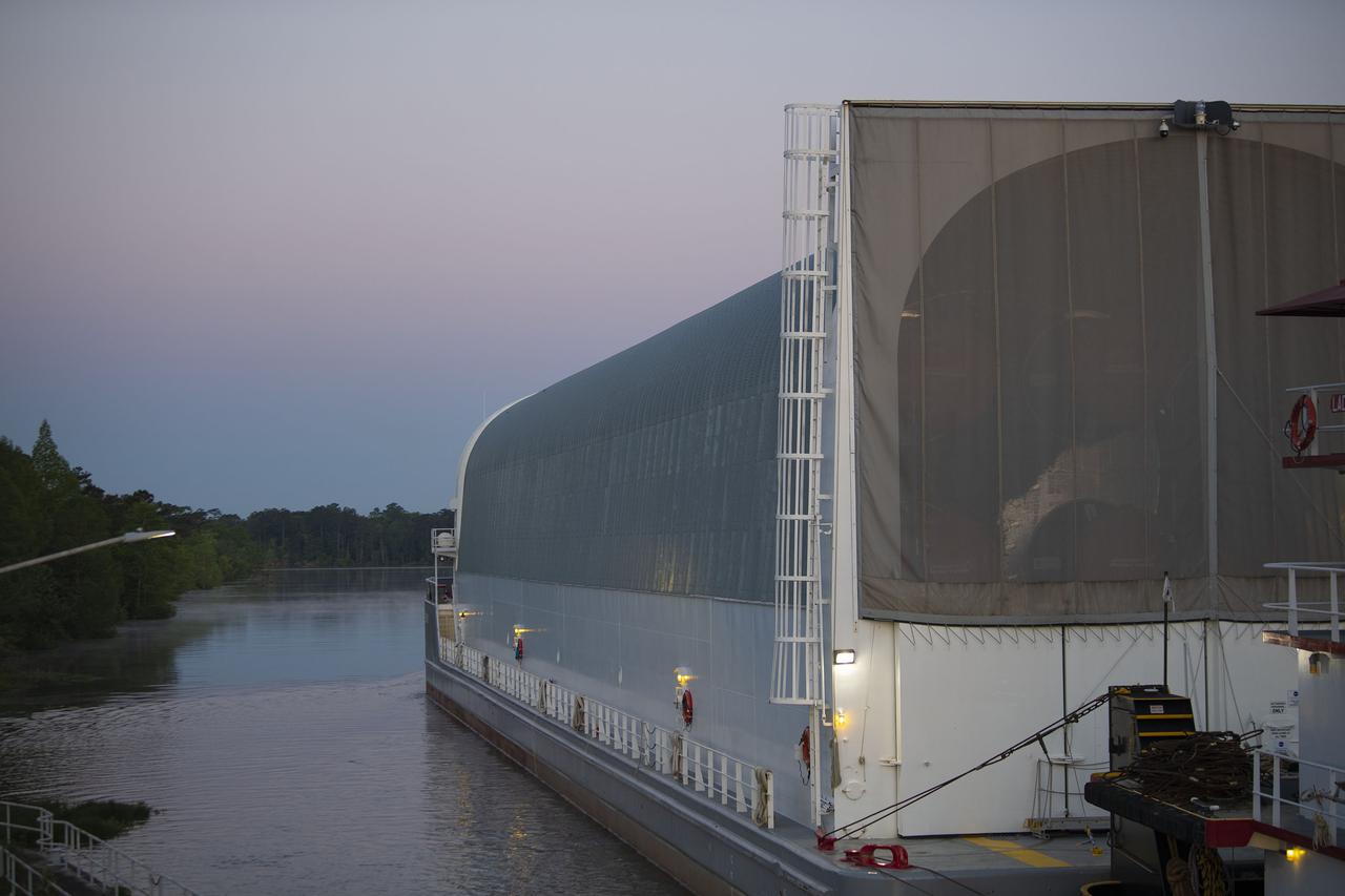 The first core stage of NASA’s Space Launch System (SLS) rocket, loaded onto the agency’s Pegasus barge, departs Stennis Space Center near Bay St. Louis, Mississippi, headed to Kennedy Space Center in Florida. The departure of the core stage in mid-April 2021 followed completion of a Green Run test series of the stage systems in preparation for its launch on the Artemis I mission. The Green Run series concluded with a March 18 hot fire of the stage’s four RS-25 engines on the B-2 Test Stand at Stennis, just as during an actual launch. Following refurbishment work, the stage was removed from the B-2 stand and loaded onto the Pegasus barge for transport. Once at Kennedy, the will be integrated with the rest of SLS rocket and prepared for the launch of the Artemis I mission to the Moon. Photo Credit: NASA