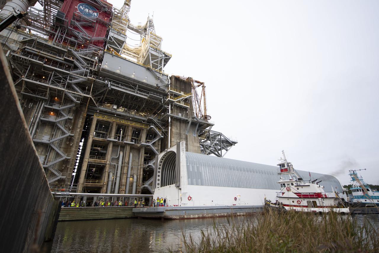 The first flight core stage for NASA’s new Space Launch System rocket arrived at Stennis Space Center on Jan. 12 for a series of tests prior to its maiden Artemis I flight. The core stage was transported from Michoud Assembly Facility in New Orleans to the B-2 Test Stand dock at Stennis aboard NASA’s Pegasus barge. Soon after arrival, the stage was rolled off of Pegasus onto the B-2 Test Stand tarmac. After the stage is lifted and installed on the B-2 stand, it will undergo a series of “Green Run” systems test that represent the first integrated testing of its sophisticated systems.