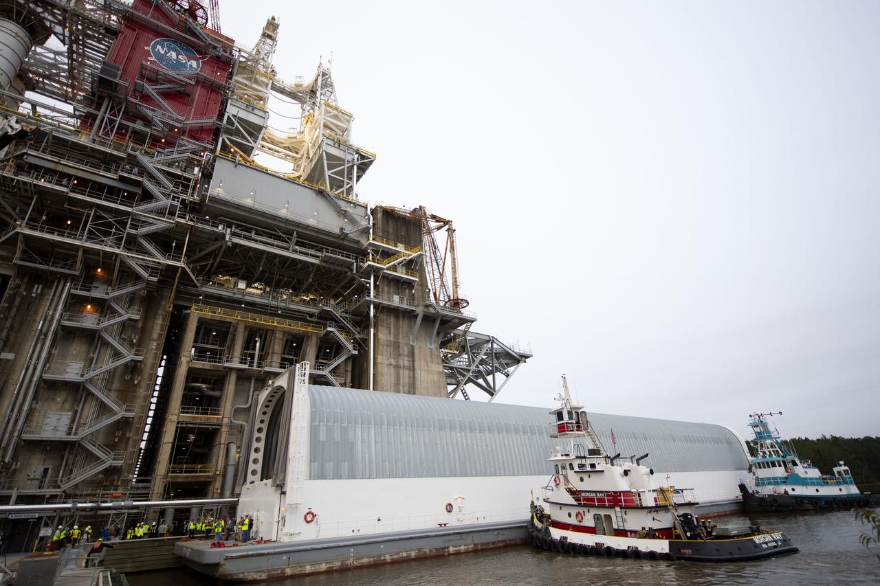 The first flight core stage for NASA’s new Space Launch System rocket arrived at Stennis Space Center on Jan. 12 for a series of tests prior to its maiden Artemis I flight. The core stage was transported from Michoud Assembly Facility in New Orleans to the B-2 Test Stand dock at Stennis aboard NASA’s Pegasus barge. Soon after arrival, the stage was rolled off of Pegasus onto the B-2 Test Stand tarmac. After the stage is lifted and installed on the B-2 stand, it will undergo a series of “Green Run” systems test that represent the first integrated testing of its sophisticated systems.