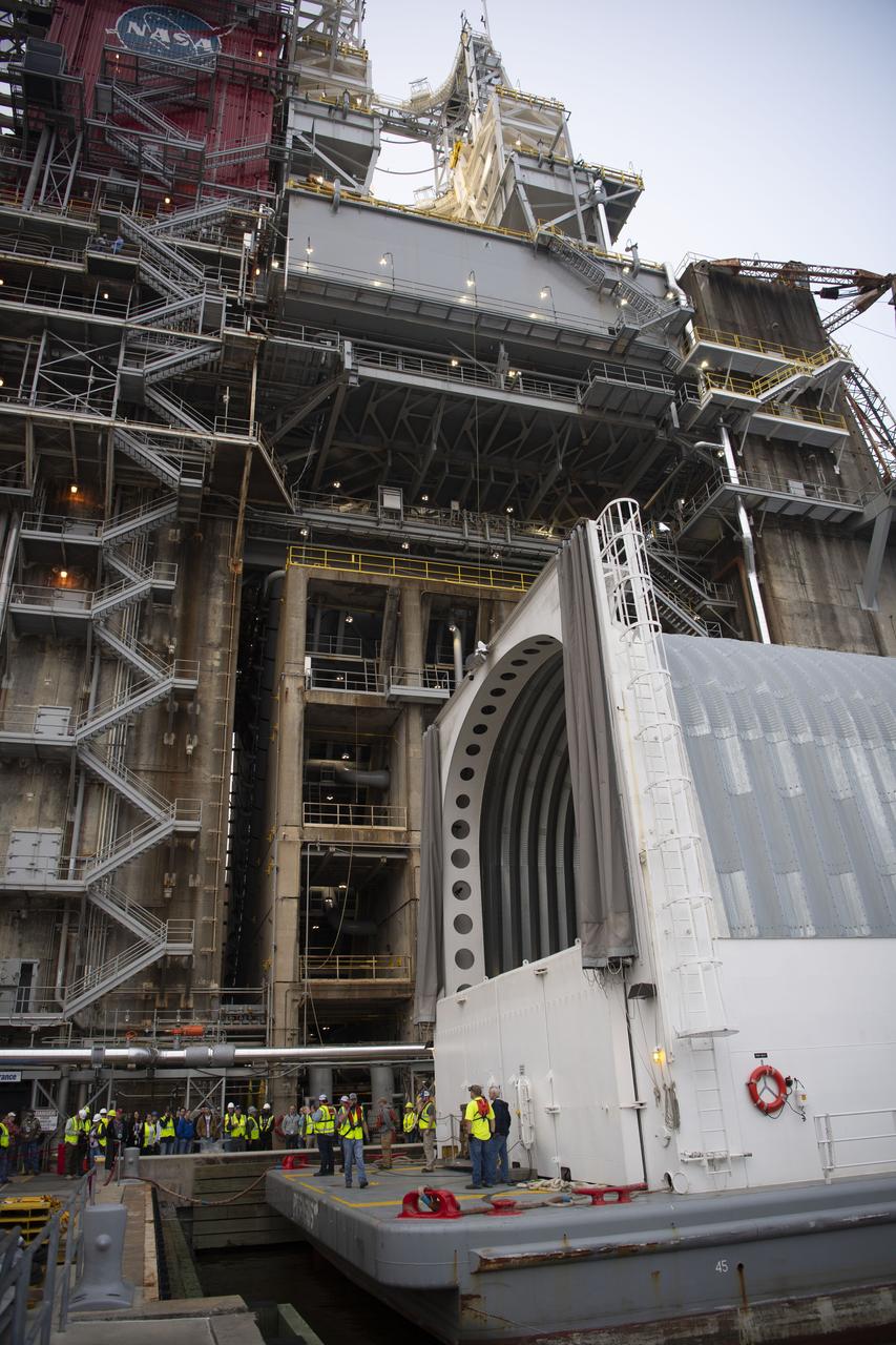 The first flight core stage for NASA’s new Space Launch System rocket arrived at Stennis Space Center on Jan. 12 for a series of tests prior to its maiden Artemis I flight. The core stage was transported from Michoud Assembly Facility in New Orleans to the B-2 Test Stand dock at Stennis aboard NASA’s Pegasus barge. Soon after arrival, the stage was rolled off of Pegasus onto the B-2 Test Stand tarmac. After the stage is lifted and installed on the B-2 stand, it will undergo a series of “Green Run” systems test that represent the first integrated testing of its sophisticated systems.