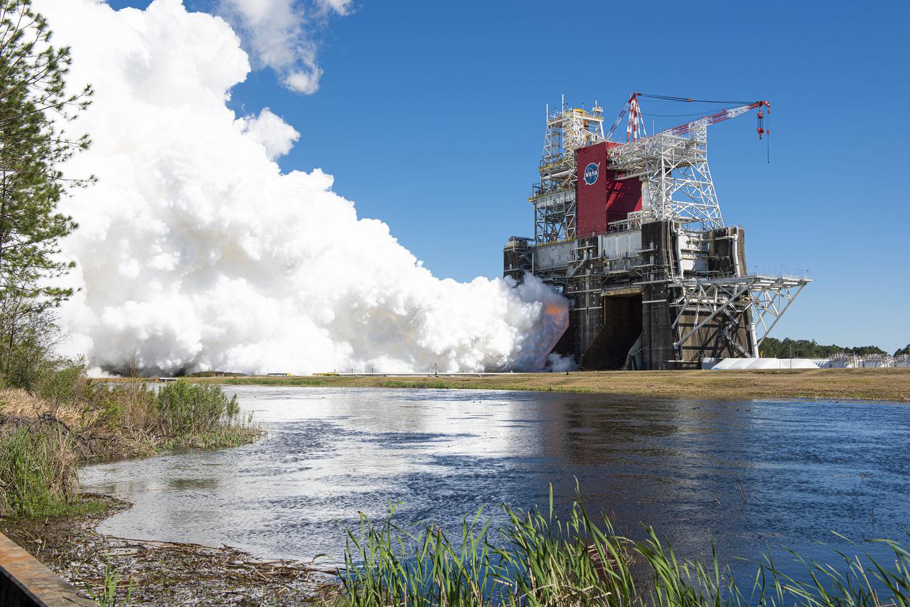 NASA conducts a hot fire test March 18, 2021, of the core stage for the agency’s Space Launch System rocket on the B-2 Test Stand at Stennis Space Center near Bay St. Louis, Mississippi. The hot fire test of the stage’s four RS-25 engines generated a combined 1.6 million pounds of thrust, just as will occur during an actual launch. The hot fire is the final test of the Green Run test series, which represents a comprehensive assessment of the core stage and its integrated systems prior to its launch on the Artemis I mission to the Moon.