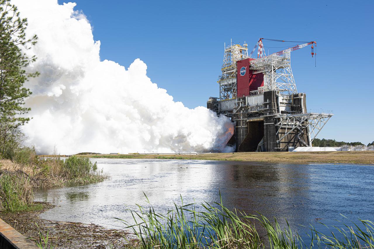 NASA conducts a hot fire test March 18, 2021, of the core stage for the agency’s Space Launch System rocket on the B-2 Test Stand at Stennis Space Center near Bay St. Louis, Mississippi. The hot fire test of the stage’s four RS-25 engines generated a combined 1.6 million pounds of thrust, just as will occur during an actual launch. The hot fire is the final test of the Green Run test series, which represents a comprehensive assessment of the core stage and its integrated systems prior to its launch on the Artemis I mission to the Moon.