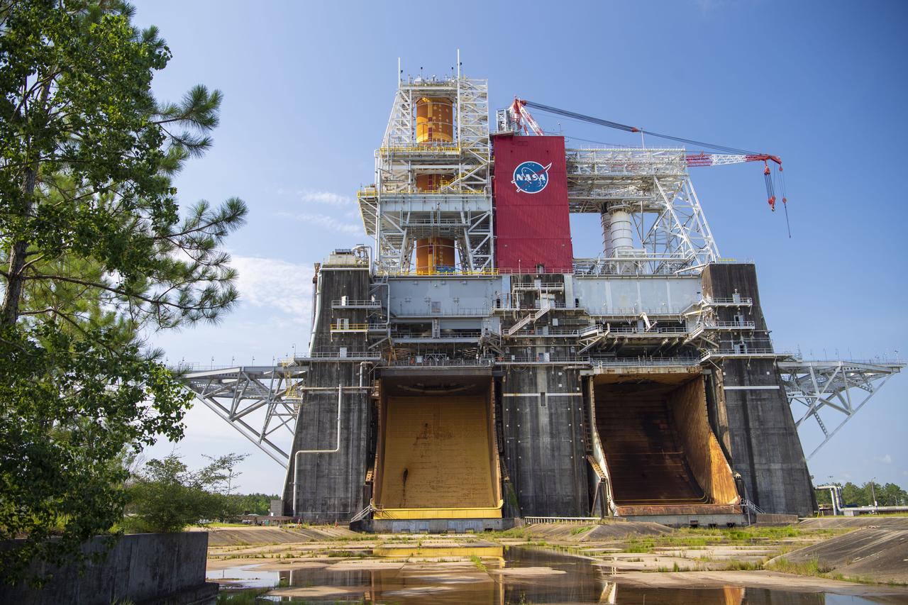 A photo from the north (flame trench) side of the B-2 Test Stand at NASA’s Stennis Space Center shows the first flight core stage for NASA’s new Space Launch System (SLS) rocket installed for Green Run testing. The SLS core stage was transported to Stennis in January to begin Green Run testing prior to its use on the Artemis I mission. NASA is building SLS to return humans, including the first woman, to the Moon as part of the Artemis program and to prepare for eventual missions to Mars. At Stennis, the SLS core stage will undergo a series of tests on its integrated systems, culminating with a hot fire of its four RS-25 engines, just as during an actual launch.