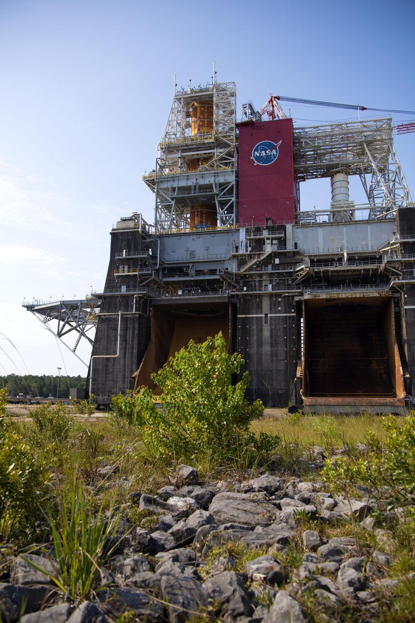 A photo from the north (flame trench) side of the B-2 Test Stand at NASA’s Stennis Space Center shows the first flight core stage for NASA’s new Space Launch System (SLS) rocket installed for Green Run testing. The SLS core stage was transported to Stennis in January to begin Green Run testing prior to its use on the Artemis I mission. NASA is building SLS to return humans, including the first woman, to the Moon as part of the Artemis program and to prepare for eventual missions to Mars. At Stennis, the SLS core stage will undergo a series of tests on its integrated systems, culminating with a hot fire of its four RS-25 engines, just as during an actual launch.