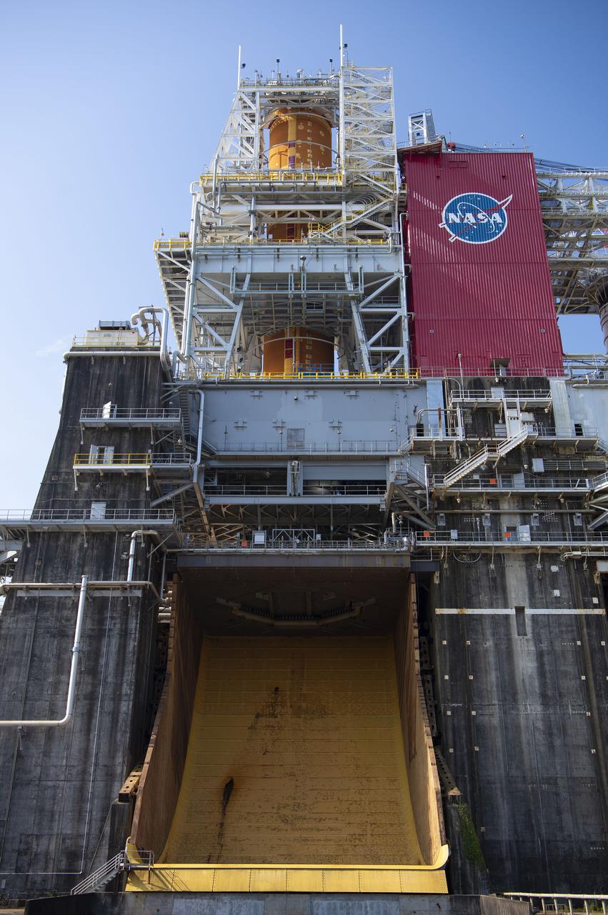 A photo from the north (flame trench) side of the B-2 Test Stand at NASA’s Stennis Space Center shows the first flight core stage for NASA’s new Space Launch System (SLS) rocket installed for Green Run testing. The SLS core stage was transported to Stennis in January to begin Green Run testing prior to its use on the Artemis I mission. NASA is building SLS to return humans, including the first woman, to the Moon as part of the Artemis program and to prepare for eventual missions to Mars. At Stennis, the SLS core stage will undergo a series of tests on its integrated systems, culminating with a hot fire of its four RS-25 engines, just as during an actual launch.