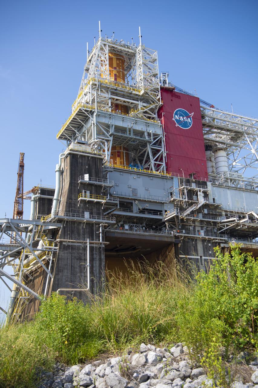 A photo from the north (flame trench) side of the B-2 Test Stand at NASA’s Stennis Space Center shows the first flight core stage for NASA’s new Space Launch System (SLS) rocket installed for Green Run testing. The SLS core stage was transported to Stennis in January to begin Green Run testing prior to its use on the Artemis I mission. NASA is building SLS to return humans, including the first woman, to the Moon as part of the Artemis program and to prepare for eventual missions to Mars. At Stennis, the SLS core stage will undergo a series of tests on its integrated systems, culminating with a hot fire of its four RS-25 engines, just as during an actual launch.