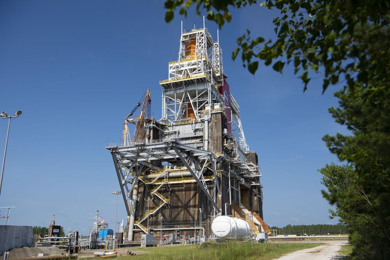 A photo from the north (flame trench) side of the B-2 Test Stand at NASA’s Stennis Space Center shows the first flight core stage for NASA’s new Space Launch System (SLS) rocket installed for Green Run testing. The SLS core stage was transported to Stennis in January to begin Green Run testing prior to its use on the Artemis I mission. NASA is building SLS to return humans, including the first woman, to the Moon as part of the Artemis program and to prepare for eventual missions to Mars. At Stennis, the SLS core stage will undergo a series of tests on its integrated systems, culminating with a hot fire of its four RS-25 engines, just as during an actual launch.