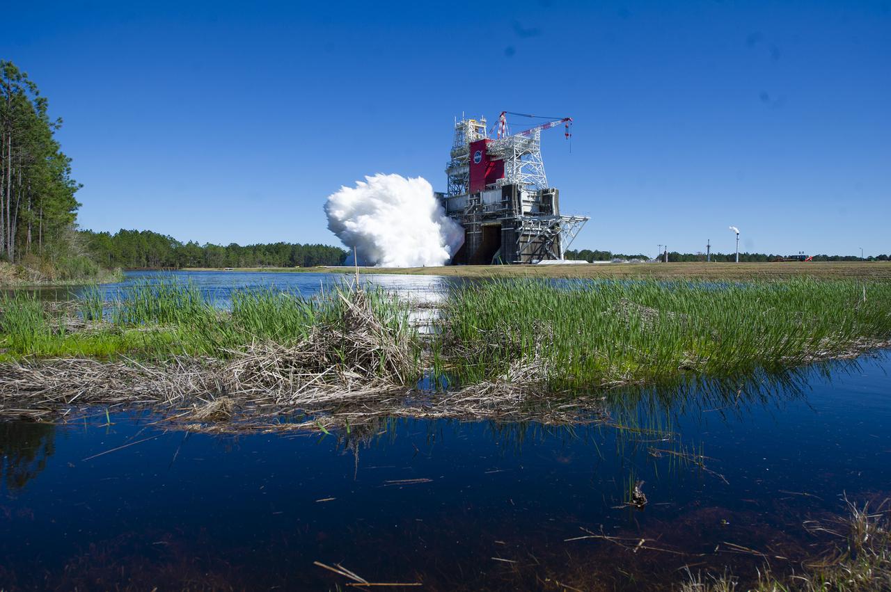 NASA conducts a hot fire test March 18, 2021, of the core stage for the agency’s Space Launch System rocket on the B-2 Test Stand at Stennis Space Center near Bay St. Louis, Mississippi. The hot fire test of the stage’s four RS-25 engines generated a combined 1.6 million pounds of thrust, just as will occur during an actual launch. The hot fire is the final test of the Green Run test series, which represents a comprehensive assessment of the core stage and its integrated systems prior to its launch on the Artemis I mission to the Moon.