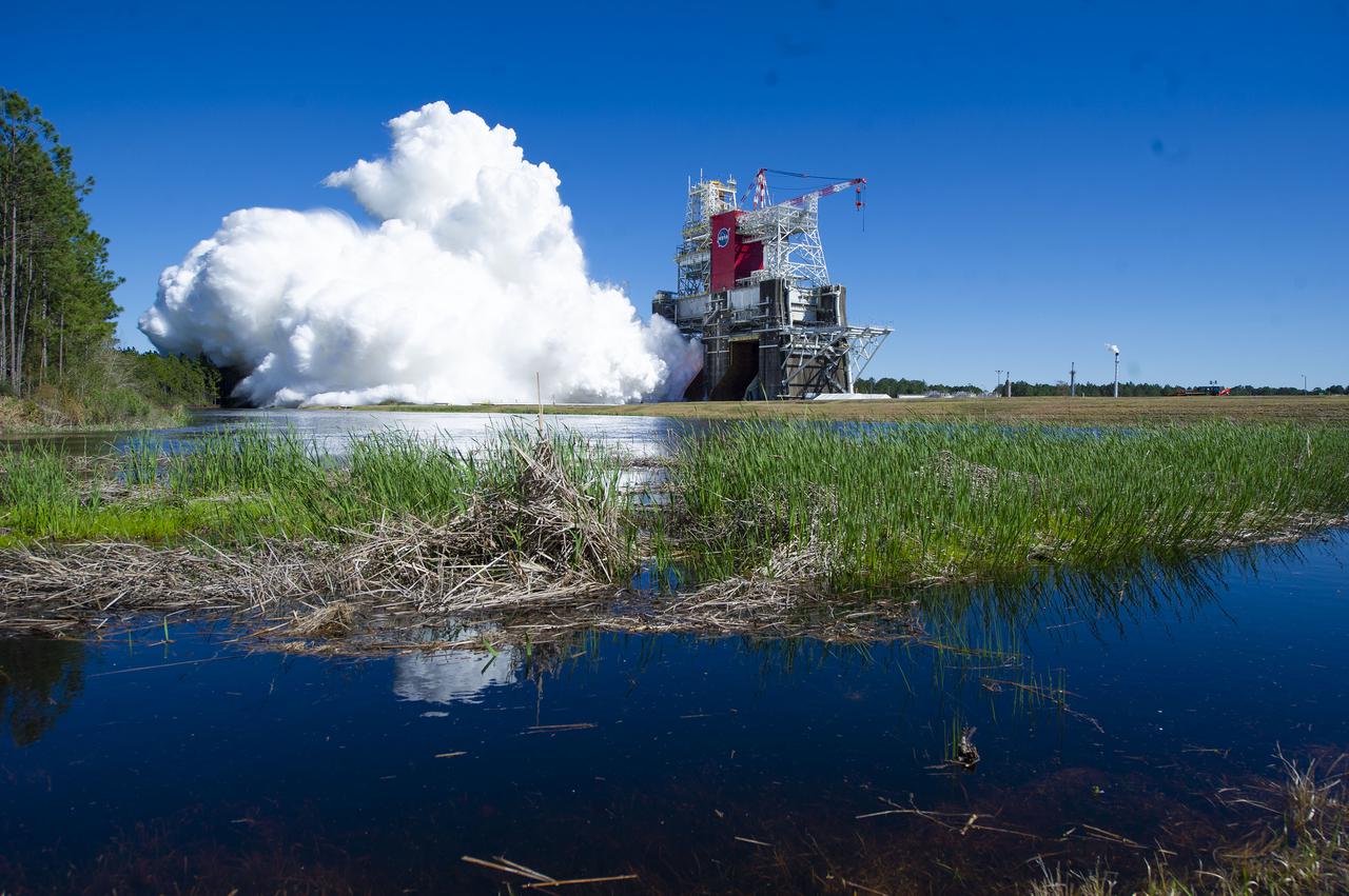 NASA conducts a hot fire test March 18, 2021, of the core stage for the agency’s Space Launch System rocket on the B-2 Test Stand at Stennis Space Center near Bay St. Louis, Mississippi. The hot fire test of the stage’s four RS-25 engines generated a combined 1.6 million pounds of thrust, just as will occur during an actual launch. The hot fire is the final test of the Green Run test series, which represents a comprehensive assessment of the core stage and its integrated systems prior to its launch on the Artemis I mission to the Moon.