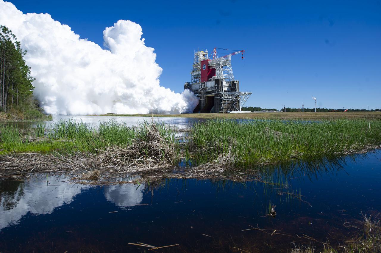 NASA conducts a hot fire test March 18, 2021, of the core stage for the agency’s Space Launch System rocket on the B-2 Test Stand at Stennis Space Center near Bay St. Louis, Mississippi. The hot fire test of the stage’s four RS-25 engines generated a combined 1.6 million pounds of thrust, just as will occur during an actual launch. The hot fire is the final test of the Green Run test series, which represents a comprehensive assessment of the core stage and its integrated systems prior to its launch on the Artemis I mission to the Moon.