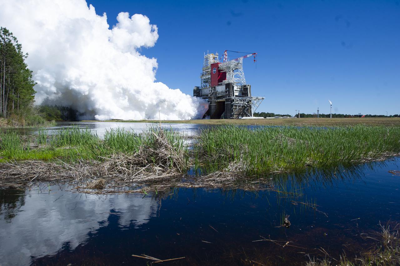 NASA conducts a hot fire test March 18, 2021, of the core stage for the agency’s Space Launch System rocket on the B-2 Test Stand at Stennis Space Center near Bay St. Louis, Mississippi. The hot fire test of the stage’s four RS-25 engines generated a combined 1.6 million pounds of thrust, just as will occur during an actual launch. The hot fire is the final test of the Green Run test series, which represents a comprehensive assessment of the core stage and its integrated systems prior to its launch on the Artemis I mission to the Moon.