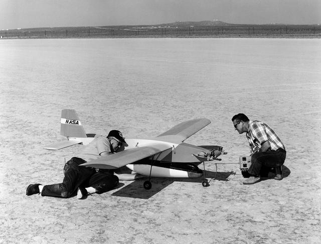 NASA image: Jim Newman and Bob McDonald attach an M2-F2 lifting body model to the "Mothership"