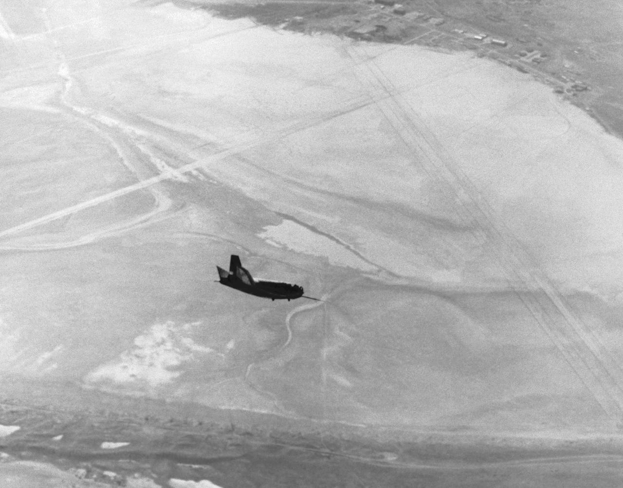 The HL-10 lifting body is seen here in flight over Rogers Dry Lake at Edwards AFB. After the vehicle's fins were modified following its first flight, the HL-10 proved to be the best handling of the heavy-weight lifting bodies flown at Edwards Air Force Base. The HL-10 flew much better than the M2-F2, and pilots were eager to fly it. 