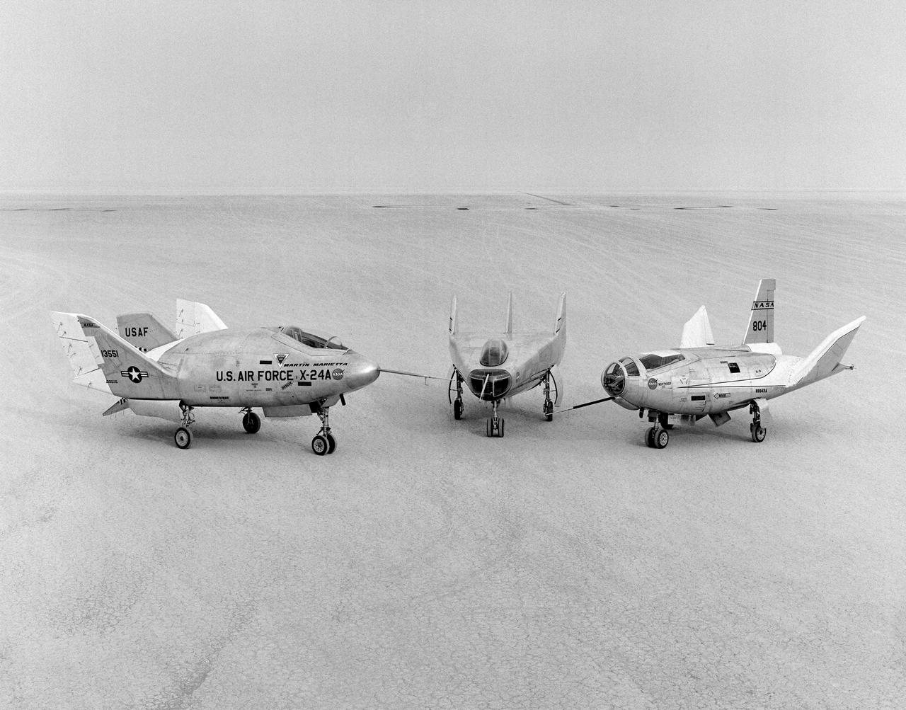 The wingless, lifting body aircraft sitting on Rogers Dry Lake at what is now NASA's Dryden Flight Research Center, Edwards, California, from left to right are the X-24A, M2-F3 and the HL-10. The lifting body aircraft studied the feasibility of maneuvering and landing an aerodynamic craft designed for reentry from space. These lifting bodies were air launched by a B-52 mother ship, then flew powered by their own rocket engines before making an unpowered approach and landing. They helped validate the concept that a space shuttle could make accurate landings without power.  The X-24A flew from April 17, 1969 to June 4, 1971. The M2-F3 flew from June 2, 1970 until December 20, 1972. The HL-10 flew from December 22, 1966 until July 17, 1970 and logged the highest and fastest records in the lifting body program.