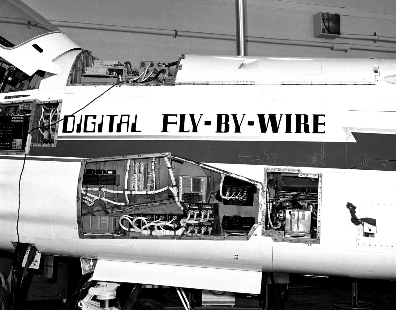 The Apollo hardware jammed into the F-8C. The computer is partially visible in the avionics bay at the top of the fuselage behind the cockpit. Note the display and keyboard unit in the gun bay. To carry the computers and other equipment, the F-8 DFBW team removed the aircraft's guns and ammunition boxes. 