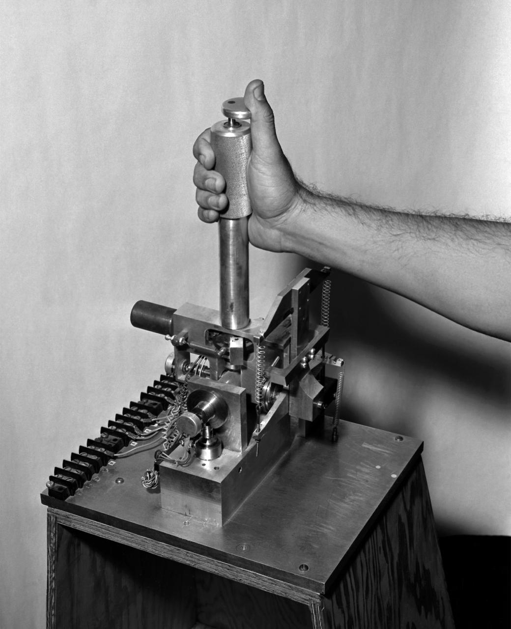 A photo of the control stick used on the Iron Cross Attitude Simulator. Although it resembled today's desktop computer flight sticks, its operation was different. As with a standard control stick, moving it back and forth raised and lowered the nose resulting in changes in pitch. Moving the stick to the right or left raised or lowered the wing, resulted in changes in roll. This control stick had a third axis, not found in standard control sticks. Twisting the stick to the right or left caused the airplane's nose to move horizontally in the same direction, resulting in changes in yaw.