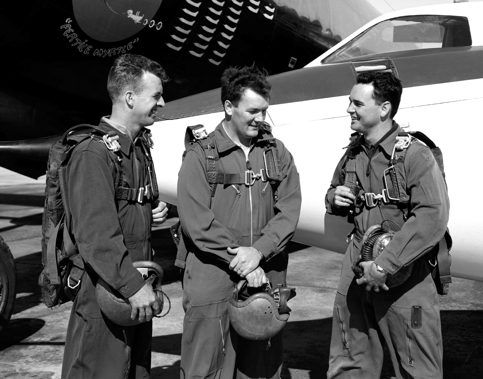 Three test pilots talk together in front of a Douglas D-558-II Skystreak in 1952