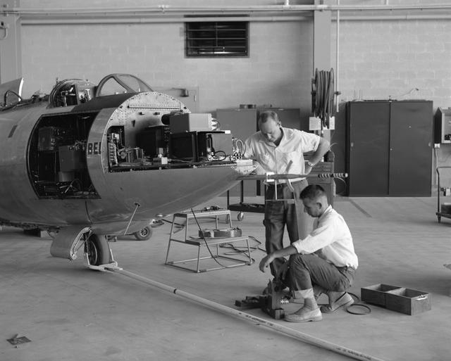 NASA image: Lee Adelsbach and Bob Cook work on the instrumentation on the Bell X-1B