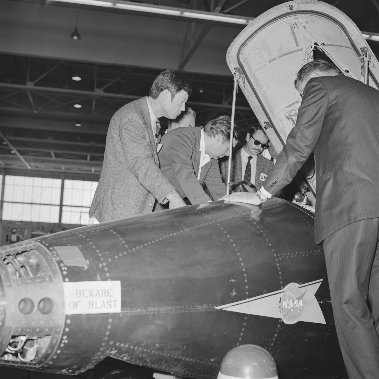The 1960s Star Trek television series’ cast members visit NASA Dryden Flight Research Center, now Armstrong, in 1967. Chief Medical Officer Leonard ‘Bones’ McCoy played by DeForest Kelley and the show’s creator Gene Roddenberry receive briefing on X-15 cockpit as they view inside. 