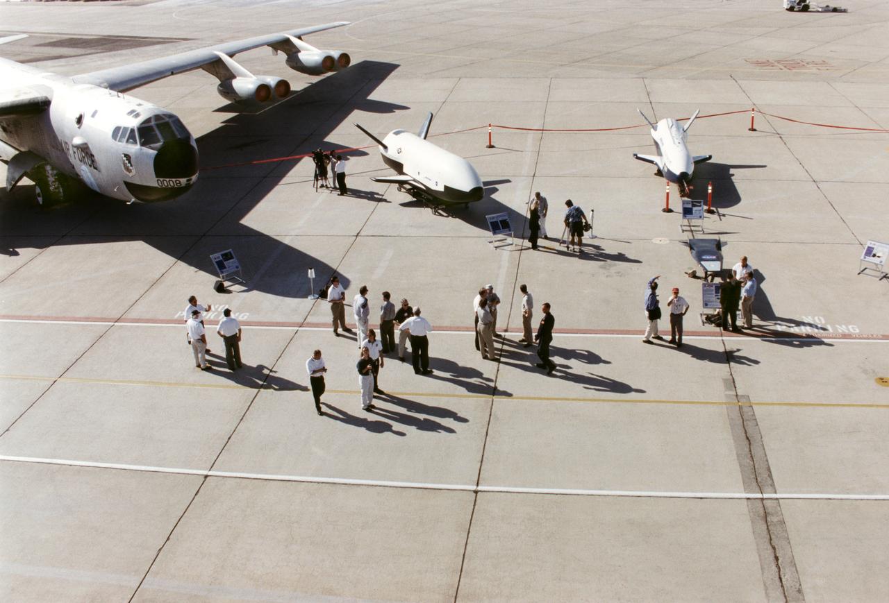 Aerospace industry representatives view actual and mock-up versions of 'X-Planes' intended to enhance access to space during a technical exposition on June 22, 2000 at Dryden Flight Research Center, Edwards, California. From left to right: NASA's B-52 launch aircraft, in service with NASA from 1959 to 2004; a neutral-buoyancy model of the Boeing's X-37; the Boeing X-40A behind the MicroCraft X-43 mock-up; Orbital Science's X-34 and the modified Lockheed L-1011 airliner that was intended to launch the X-34.  These X-vehicles are part of NASA's Access to Space plan intended to bring new technologies to bear in an effort to dramatically lower the cost of putting payloads in space, and near-space environments. The June 22, 2000 NASA Reusable Launch Vehicle (RLV) Technology Exposition included presentations on the history, present, and future of NASA's RLV program. Special Sessions for industry representatives highlighted the X-37 project and its related technologies. The X-37 project is managed by NASA's Marshall Space Flight Center, Huntsville, Alabama.