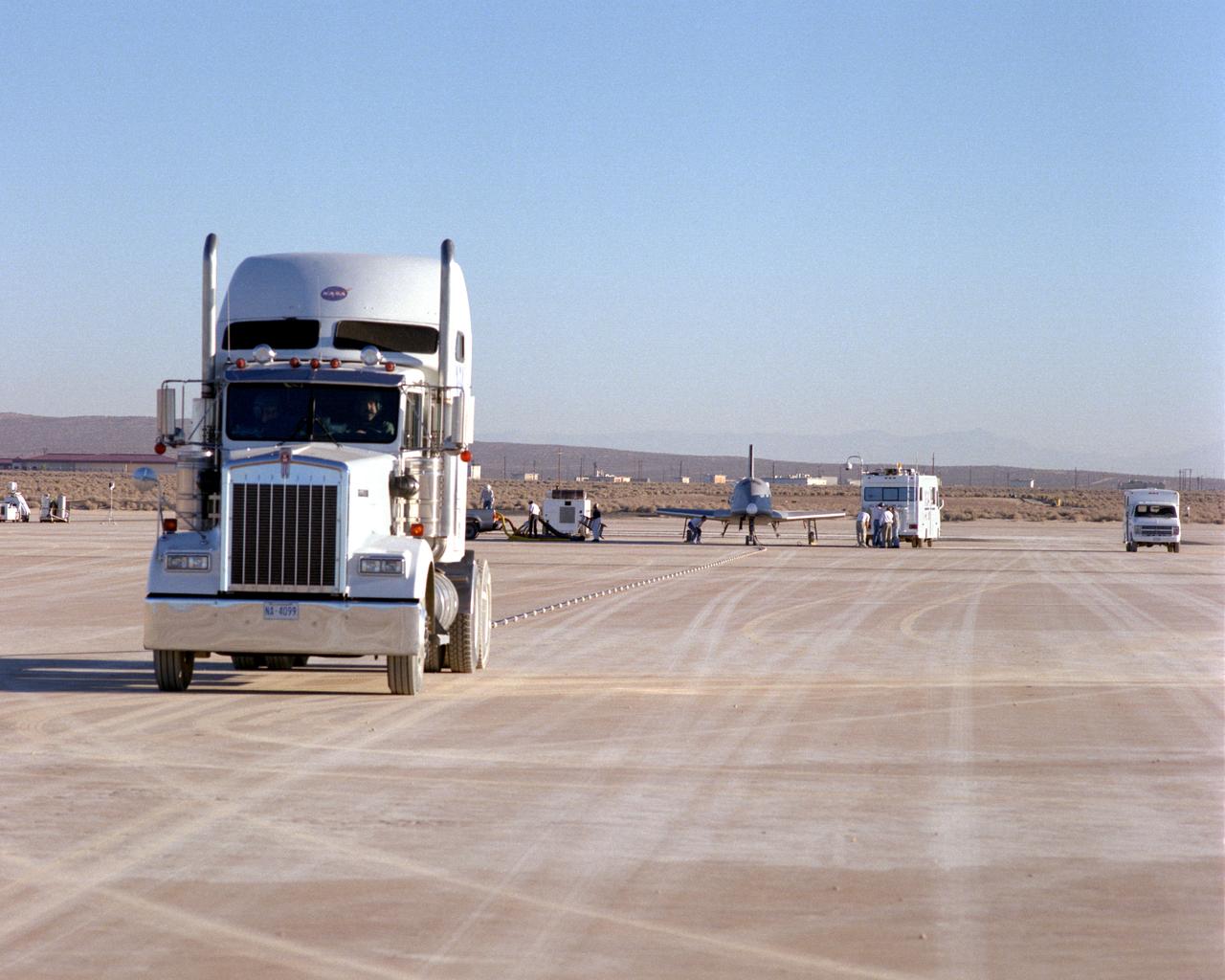 Following initial captive flight tests last year at NASA's Dryden Flight Research Center, Edwards Air Force Base, California, the X-34 technology demonstrator began a new series of tests last week in which it is being towed behind a semi-truck and released to coast on the Edwards dry lakebed. On July 20, 2000, it was towed and released twice at speeds of five and 10 miles per hour. On July 24, 2000, it was towed and released twice at 10 and 30 miles per hour. Twelve tests are planned during which the X-34 will be towed for distances up to 10,000 feet and released at speeds up to 80 miles per hour. The test series is expected to last at least six weeks.