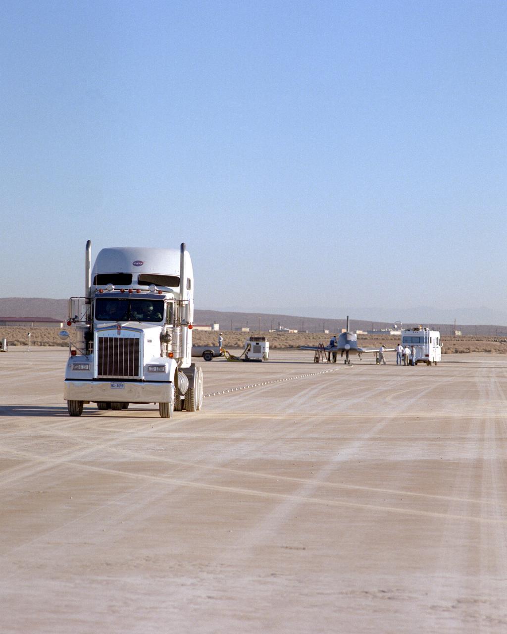 Following initial captive flight tests last year at NASA's Dryden Flight Research Center, Edwards Air Force Base, California, the X-34 technology demonstrator began a new series of tests last week in which it is being towed behind a semi-truck and released to coast on the Edwards dry lakebed. On July 20, 2000, it was towed and released twice at speeds of five and 10 miles per hour. On July 24, 2000, it was towed and released twice at 10 and 30 miles per hour. Twelve tests are planned during which the X-34 will be towed for distances up to 10,000 feet and released at speeds up to 80 miles per hour. The test series is expected to last at least six weeks.