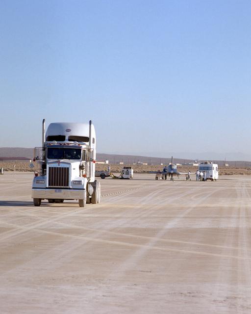NASA image: X-34 and HSTV tow vehicle on lakebed prior to tow test