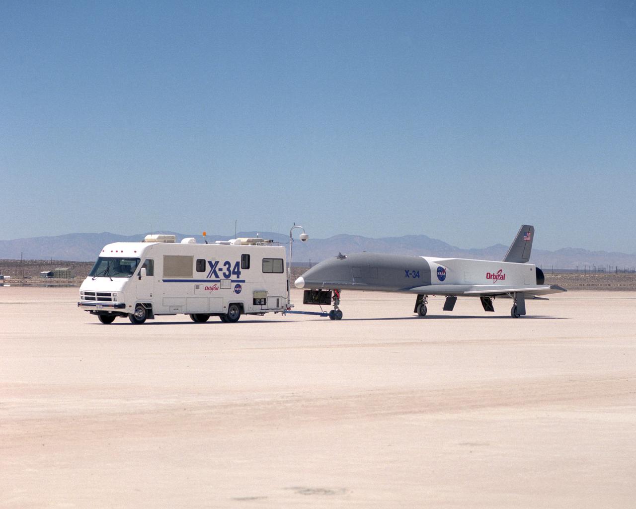 Following initial captive flight tests last year at NASA's Dryden Flight Research Center, Edwards Air Force Base, California, the X-34 technology demonstrator began a new series of tests last week in which it is being towed behind a semi-truck and released to coast on the Edwards dry lakebed. On July 20, 2000, it was towed and released twice at speeds of five and 10 miles per hour. On July 24, 2000, it was towed and released twice at 10 and 30 miles per hour. Twelve tests are planned during which the X-34 will be towed for distances up to 10,000 feet and released at speeds up to 80 miles per hour. The test series is expected to last at least six weeks.