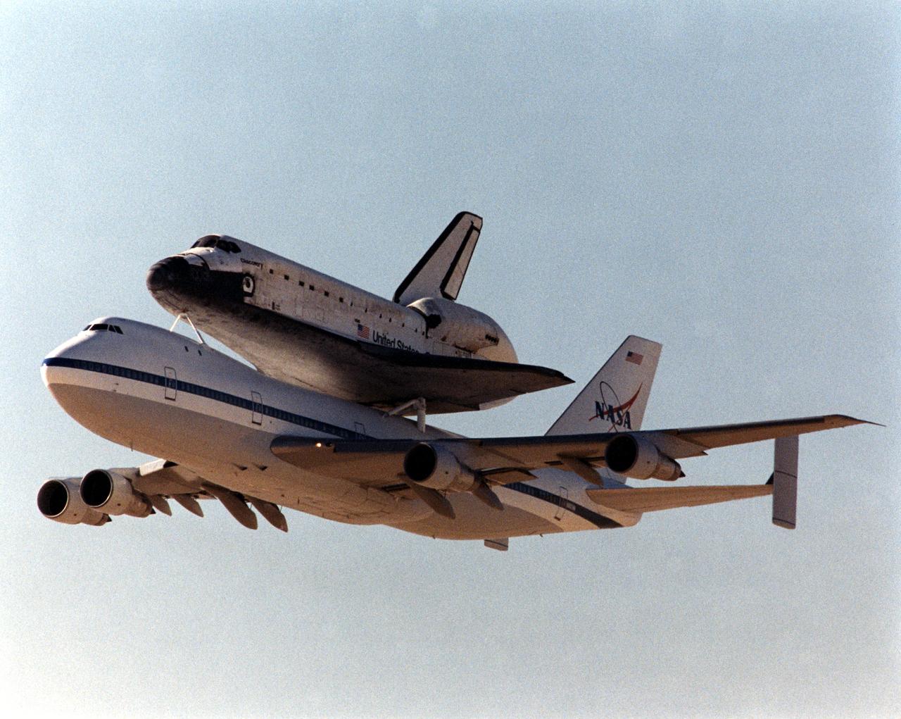 One of NASA’s two modified Boeing 747 Shuttle Carrier Aircraft with the Space Shuttle orbiter Discovery on its back climbs out after takeoff from Edwards Air Force Base, California. The Discovery was ferried from NASA’s Dryden Flight Research Center at Edwards to NASA’s Kennedy Space Center in Florida on November 2, 2000, after extensive post-landing servicing and ferry flight preparations.