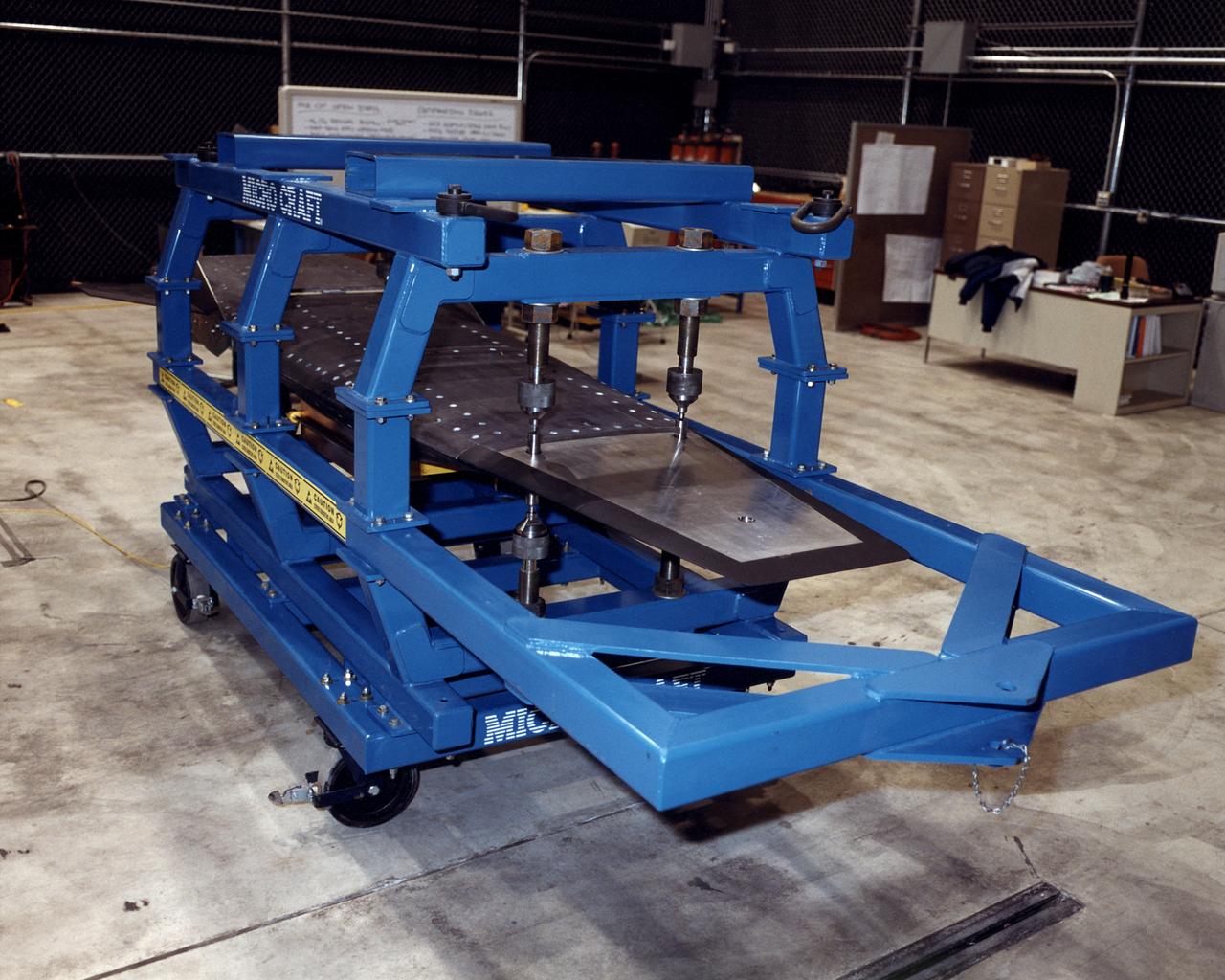 The second of three X-43A hypersonic research aircraft, shown here in its protective shipping jig, arrived at NASA's Dryden Flight Research Center, Edwards, California, on January 31, 2001. The arrival of the second X-43A from its manufacturer, MicroCraft, Inc., of Tullahoma, Tenn., followed by only a few days the mating of the first X-43A and its specially-designed adapter to the first stage of a modified Pegasus® booster rocket. The booster, built by Orbital Sciences Corp., Dulles, Va., will accelerate the 12-foot-long, unpiloted research aircraft to a predetermined altitude and speed after the X-43A/booster "stack" is air-launched from NASA's venerable NB-52 mothership. The X-43A will then separate from the rocket and fly a pre-programmed trajectory, conducting aerodynamic and propulsion experiments until it impacts into the Pacific Ocean. Three research flights are planned, two at Mach 7 and one at Mach 10 (seven and 10 times the speed of sound respectively) with the first tentatively scheduled for early summer, 2001. The X-43A is powered by a revolutionary supersonic-combustion ramjet ("scramjet") engine, and will use the underbody of the aircraft to form critical elements of the engine. The forebody shape helps compress the intake airflow, while the aft section acts as a nozzle to direct thrust. The X-43A flights will be the first actual flight tests of an aircraft powered by an air-breathing scramjet engine.