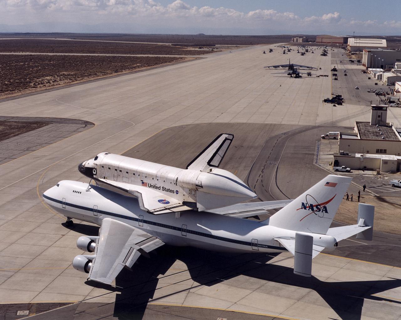 NASA's space shuttle Atlantis and its 747 carrier taxied on the Edwards Air Force Base flightline as the unusual combination left for Kennedy Space Center, Florida, on March 1, 2001. Atlantis and the shuttle Columbia were both airborne on the same day as they migrated from California to Florida. Columbia underwent refurbishing at nearby Palmdale, California.