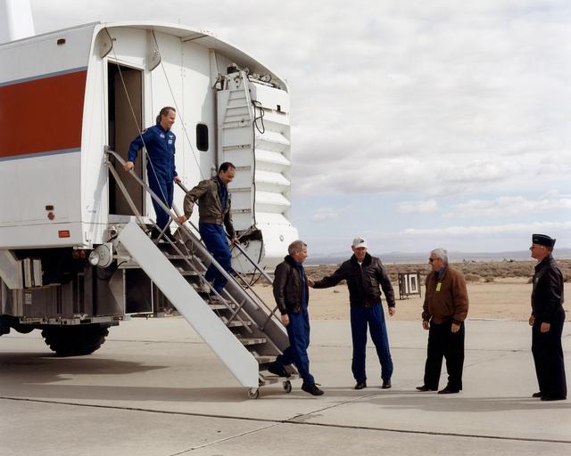 NASA image: L to R: STS-98 Mission Specialist Thomas Jones, Pilot Mark Polansky, and Commander Kenneth Cockrell greet STS-92 Commander Brian Duffy, Dryden Center Director Kevin Petersen, and AFFTC Commander Major General Richard Reynolds