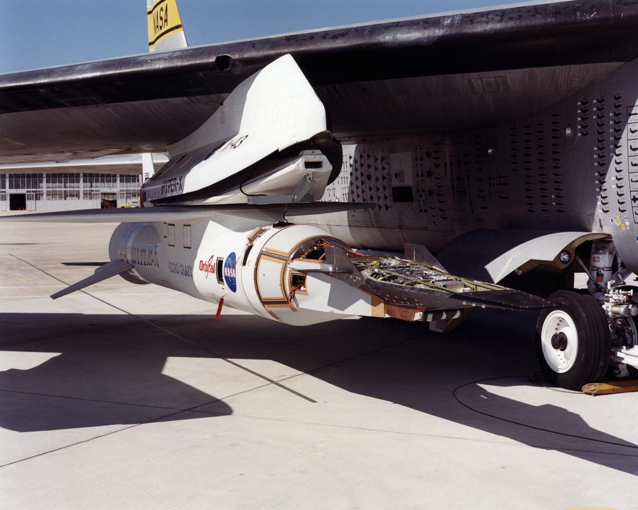 The first of three X-43A hypersonic research aircraft and its modified Pegasus® booster rocket recently underwent combined systems testing while mounted to NASA's NB-52B carrier aircraft at the Dryden Flight Research Center, Edwards, California. The combined systems test was one of the last major milestones in the Hyper-X research program before the first X-43A flight. One of the major goals of the Hyper-X program is flight validation of airframe-integrated, air-breathing propulsion system, which so far have only been tested in ground facilities, such as wind tunnels. The X-43A flights will be the first actual flight tests of an aircraft powered by a revolutionary supersonic-combustion ramjet ("scramjet") engine capable of operating at hypersonic speeds above Mach 5 (five times the speed of sound). The X-43A design uses the underbody of the aircraft to form critical elements of the engine. The forebody shape helps compress the intake airflow, while the aft section acts as a nozzle to direct thrust. The 12-foot, unpiloted research vehicle was developed and built by MicroCraft Inc., Tullahoma, Tenn., under NASA contract. The booster, built by Orbital Sciences Corp., Dulles, Va., will accelerate the X-43A after the X-43A/booster "stack" is air-launched from NASA's venerable NB-52 mothership. The X-43A will separate from the rocket at a predetermined altitude and speed and fly a pre-programmed trajectory, conducting aerodynamic and propulsion experiments until it descends into the Pacific Ocean. Three research flights are planned, two at Mach 7 and one at Mach 10.