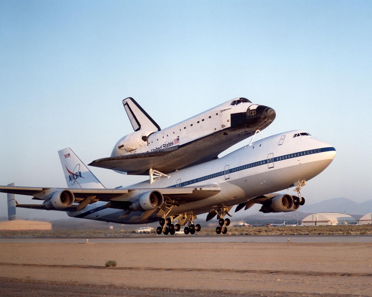 NASA's modified Boeing 747 Shuttle Carrier Aircraft with the Space Shuttle Endeavour on top lifts off from Edwards Air Force Base to begin its ferry flight back to the Kennedy Space Center in Florida.