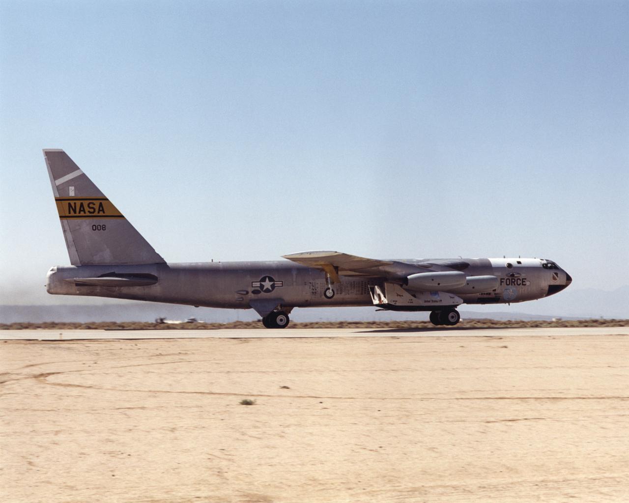 The X-38, mounted beneath the right wing of NASA's B-52, climbed from the runway at Edwards Air Force Base for the seventh free flight test of the X-38, July 10, 2001. The X-38 was released at 37,500 feet and completed a thirteen minute glide flight to a landing on Rogers Dry Lake.