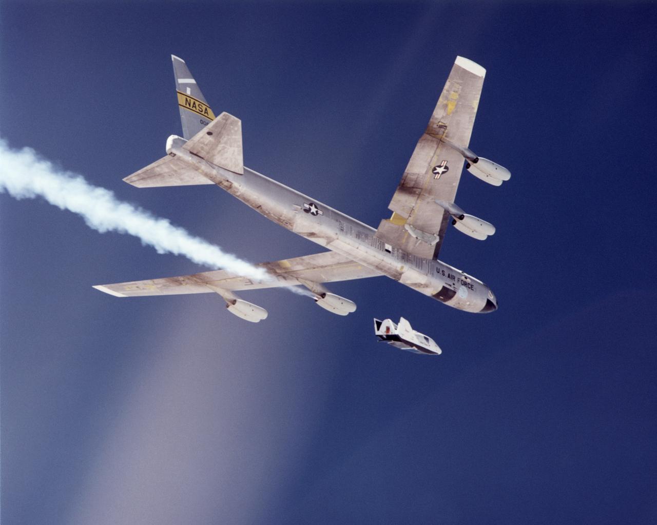The second free-flight test of an evolving series of X-38 prototypes took place July 10, 2001 when the X-38 was released from NASA's B-52 mothership over the Edwards Air Force Base range in California's Mojave Desert. Shortly after the photo was taken, a sequenced deployment of a drogue parachute followed by a large parafoil fabric wing slowed the X-38 to enable it to land safely on Rogers Dry Lake at Edwards. NASA engineers from the Dryden Flight Research Center at Edwards, and the Johnson Space Center, Houston, Texas, are developing a "lifeboat" for the International Space Station based on X-38 research.