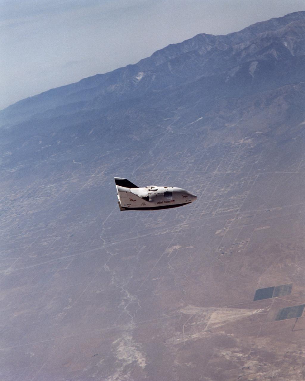 NASA's X-38 glided high over California desert test ranges as it descended from 37,500 feet to land on Rogers Dry Lake for the seventh free flight of the program July 10, 2001.