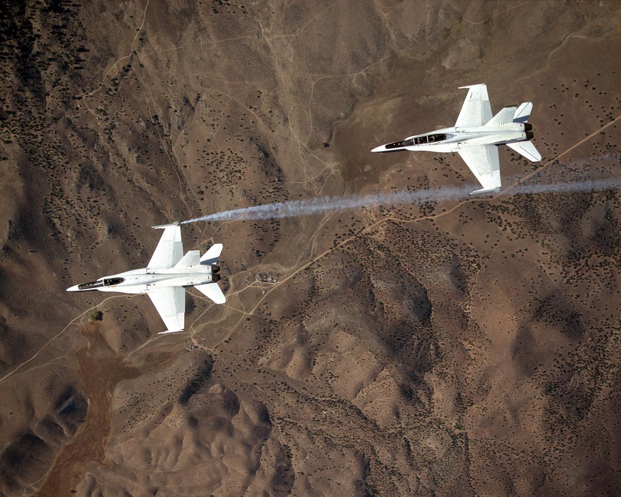 Smoke generators show the twisting paths of wingtip vortices behind two NASA Dryden F/A-18's used in the Autonomous Formation Flight (AFF) program during flight #743.