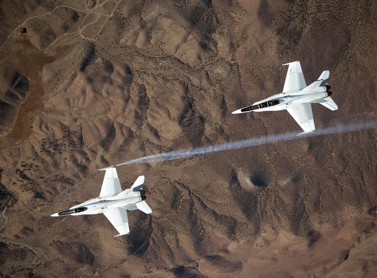 Smoke generators show the twisting paths of wingtip vortices behind two NASA Dryden F/A-18's used in the Autonomous Formation Flight (AFF) program during flight #743.